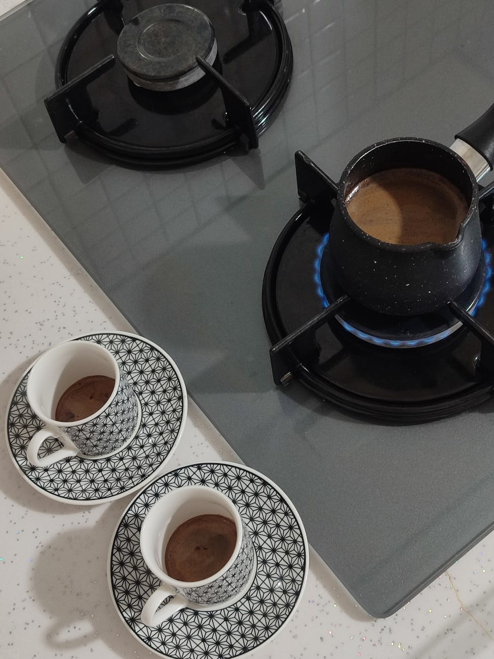 Geometrik fincan tasarımına sahip şık ocak üstü kahve makinesi, zarafet ve sıcaklık katıyor.